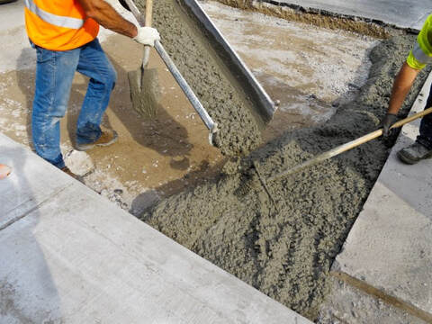 An image of two person working on a concrete repair service