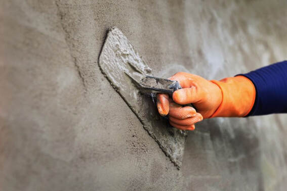 An image of a person working on a concrete repair service