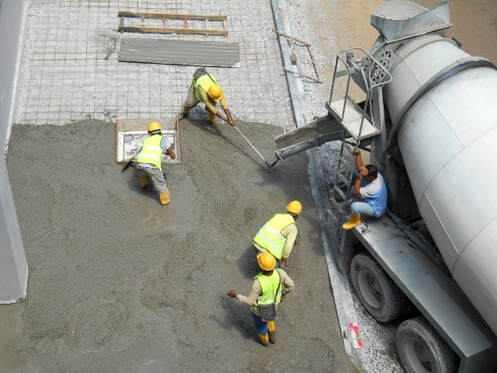 An image of three persons working on a concrete leveling service